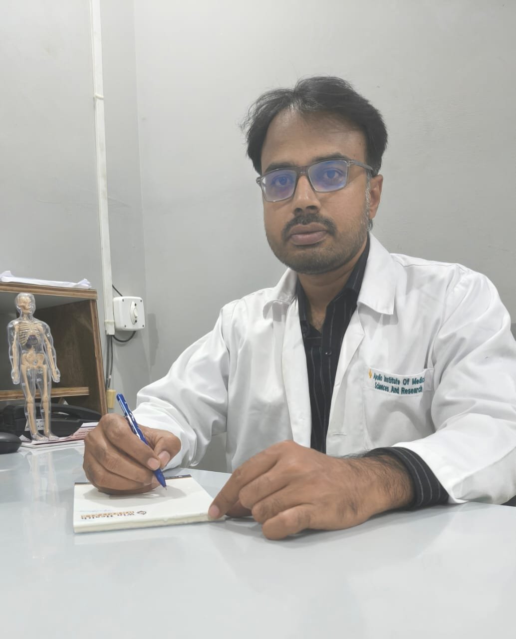 Dr. Vanka Ashok Kumar Reddy, Associate Professor and Orthopaedic Surgeon, at his consultation desk